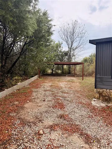 a view of a yard with a tree
