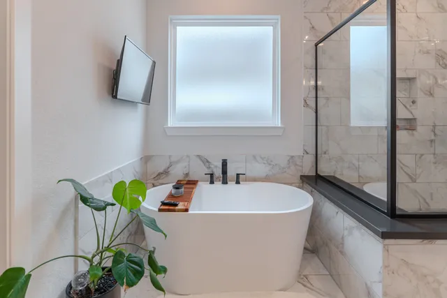 a white bath tub sitting next to a white sink