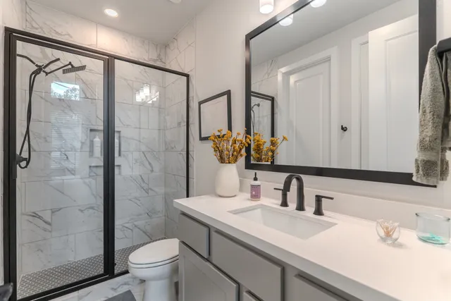 a bathroom with a sink toilet and shower