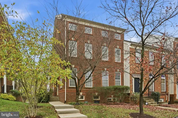 a living room with furniture and a hard wood floor