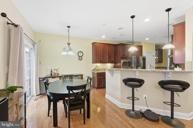 a kitchen with granite countertop wooden cabinets and sink