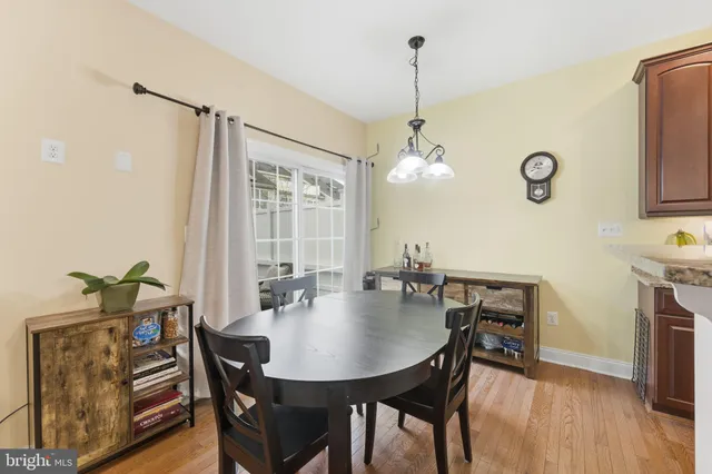 a kitchen with stainless steel appliances granite countertop a stove top oven a sink dishwasher a refrigerator and cabinets with wooden floor