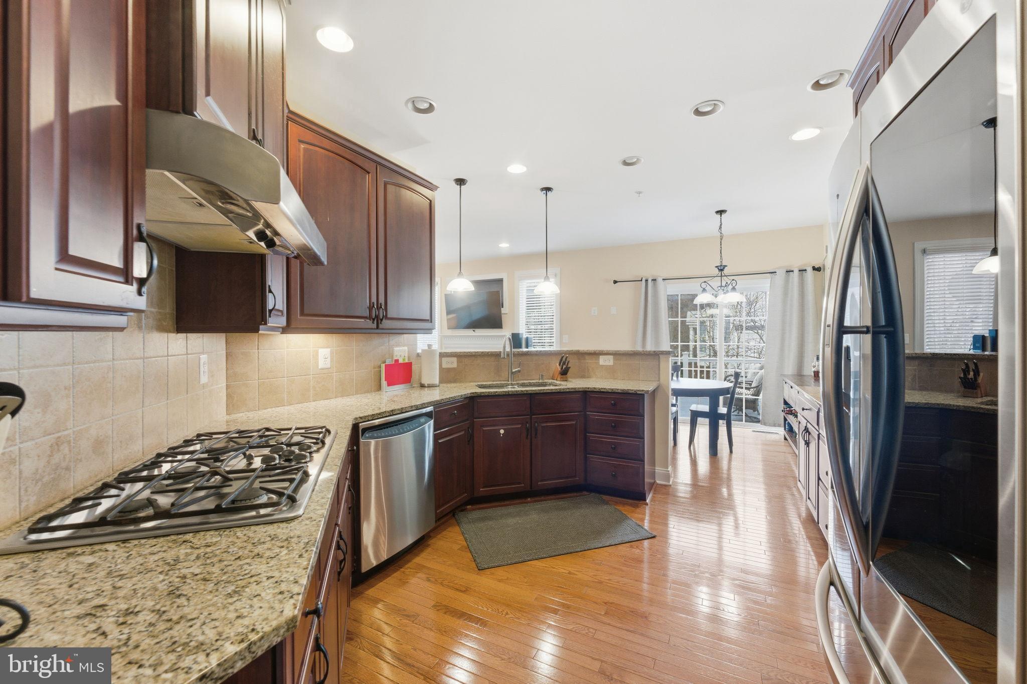 7611 Elmcrest Road Hanover, MD 21076 - Photo 19 of 64 Elegant kitchen with rich wood cabinetry.