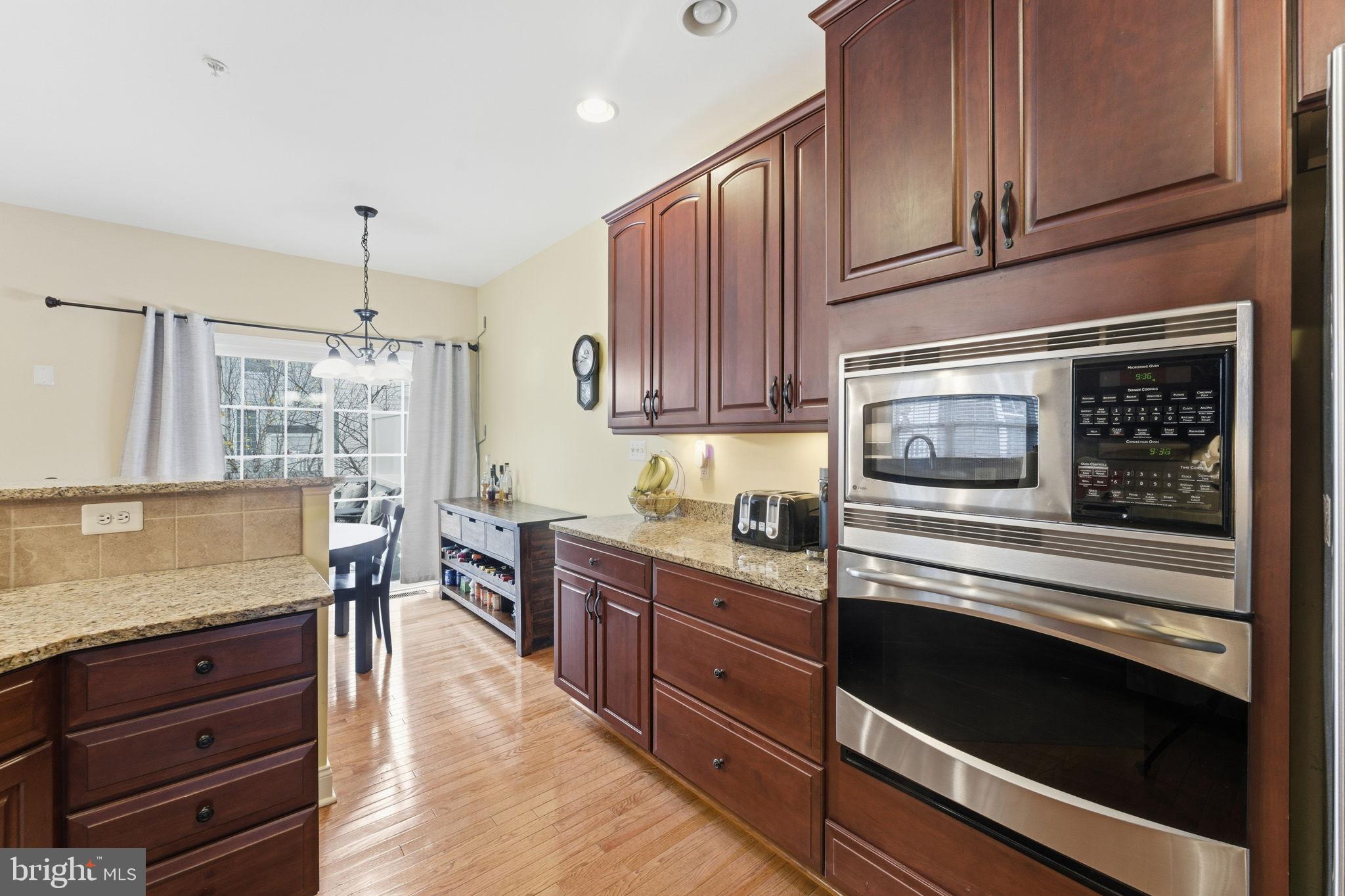 7611 Elmcrest Road Hanover, MD 21076 - Photo 20 of 64 Elegant kitchen with rich wood cabinetry.