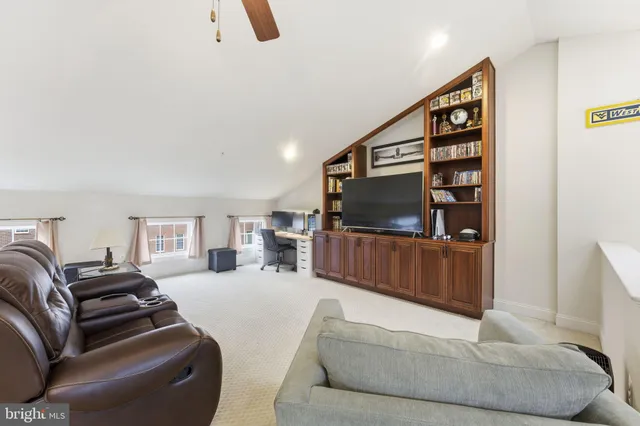 a spacious bedroom with a bed and glass windows