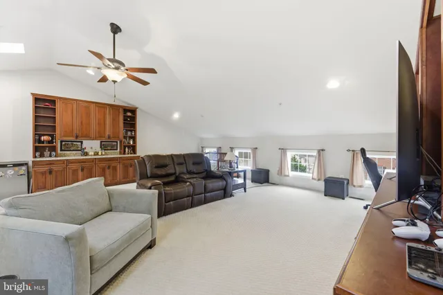 a spacious bedroom with a bed and couch