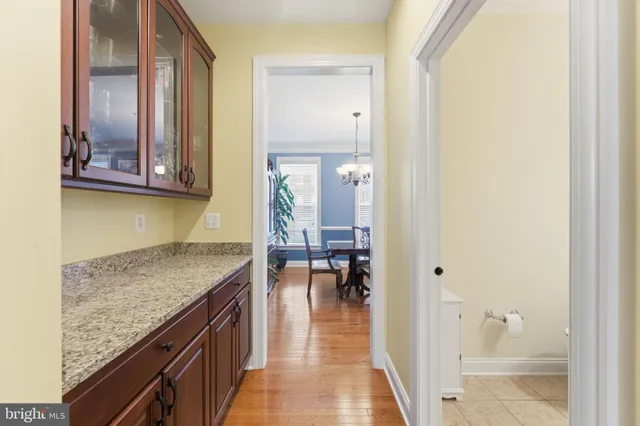 a kitchen with a dining table chairs sink and cabinets