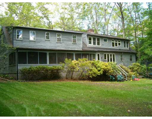 135 Red Gate Lane Amherst, MA 01002 - Photo 3 of 15 a front view of a house with a yard and garden