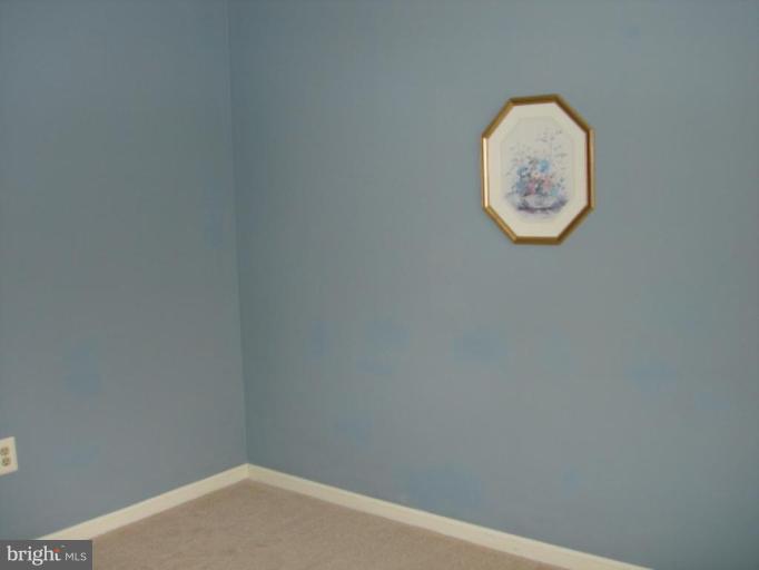 3116 Newcastle Lane Riva, MD 21140 - Photo 18 of 23 an empty room with a white wall and a clock