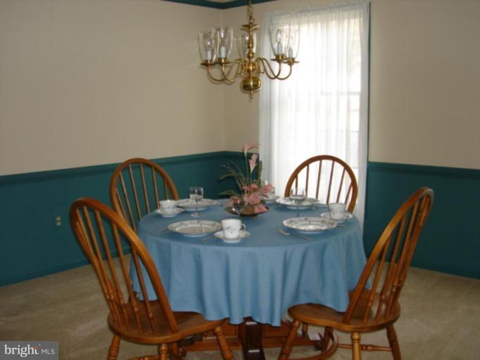 3116 Newcastle Lane Riva, MD 21140 - Photo 7 of 23 a view of a dining room with furniture a chandelier and wooden floor