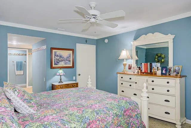 a bedroom with a bed and a dresser in it