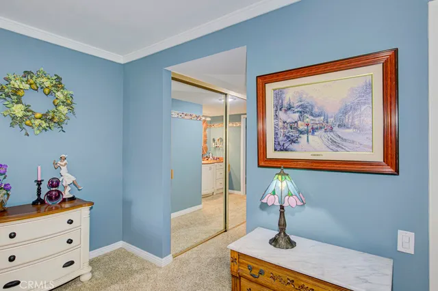 a bedroom with a bed and a cabinet