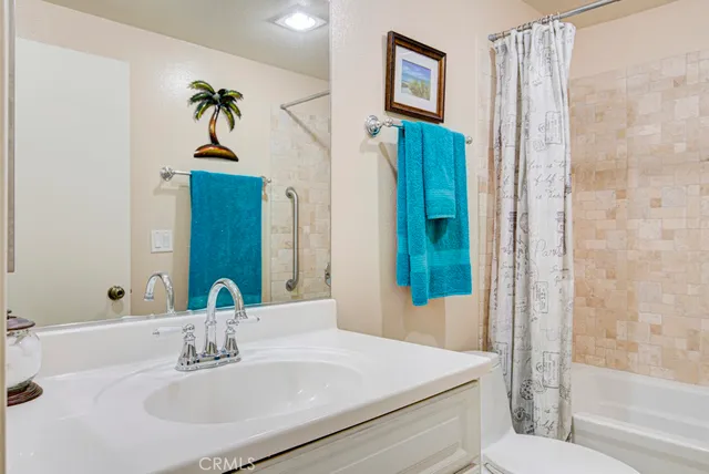 a bathroom with a sink mirror and vanity