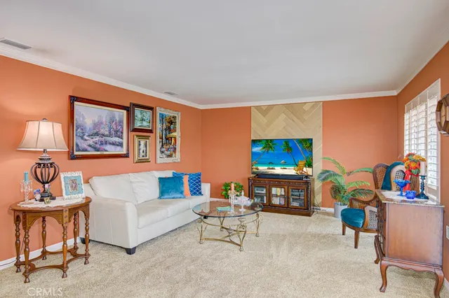 a living room with furniture a rug and a painting on the wall