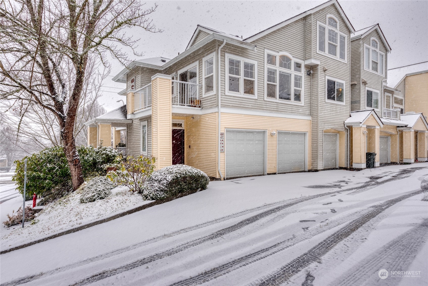 4700 Talbot Road South, Unit 400G Renton, WA 98055 - Photo 1 of 20 a front view of a house with a yard and garage