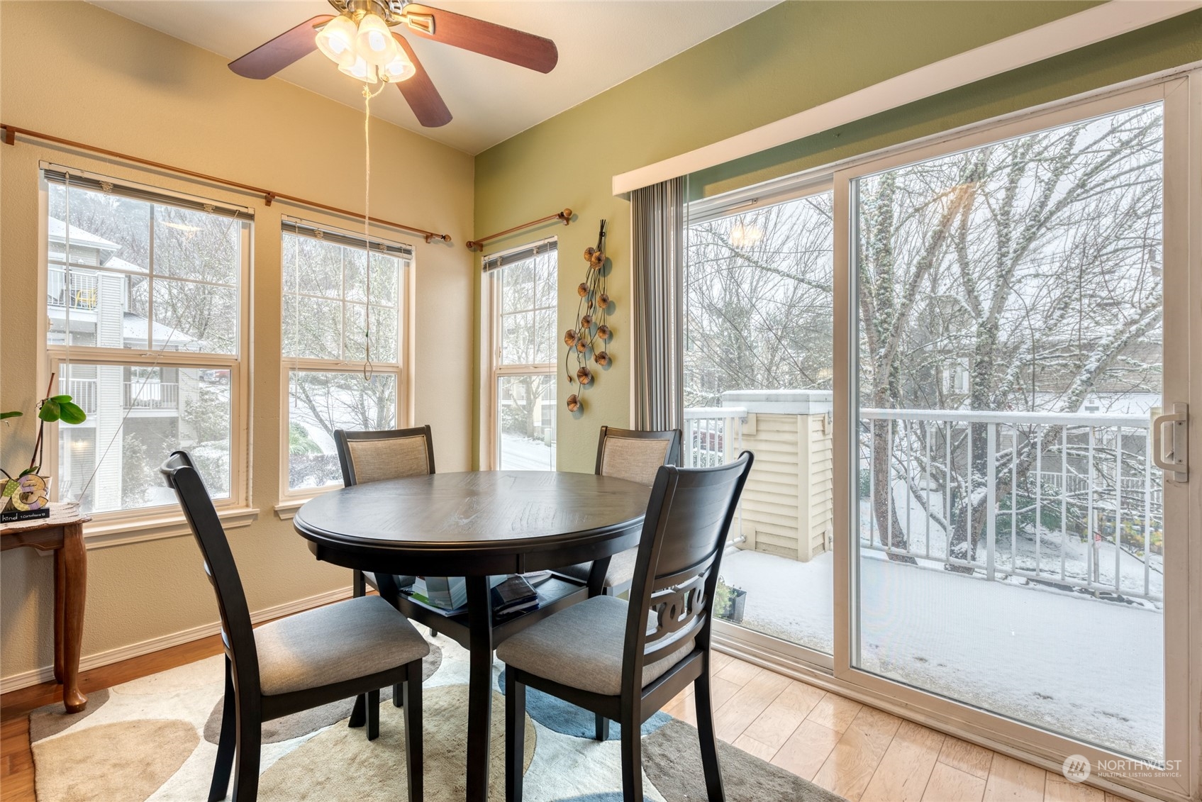 4700 Talbot Road South, Unit 400G Renton, WA 98055 - Photo 6 of 20 a view of a dining room with furniture large windows and wooden floor