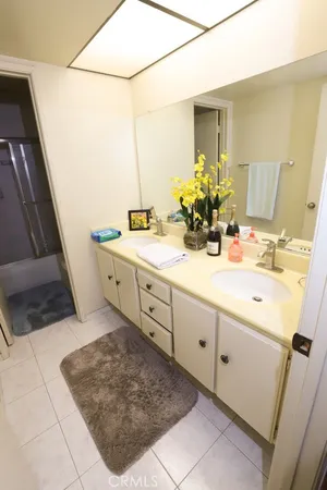 a view of a house with potted plants and a barbeque