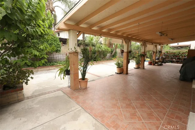 a view of a porch with a table and chairs