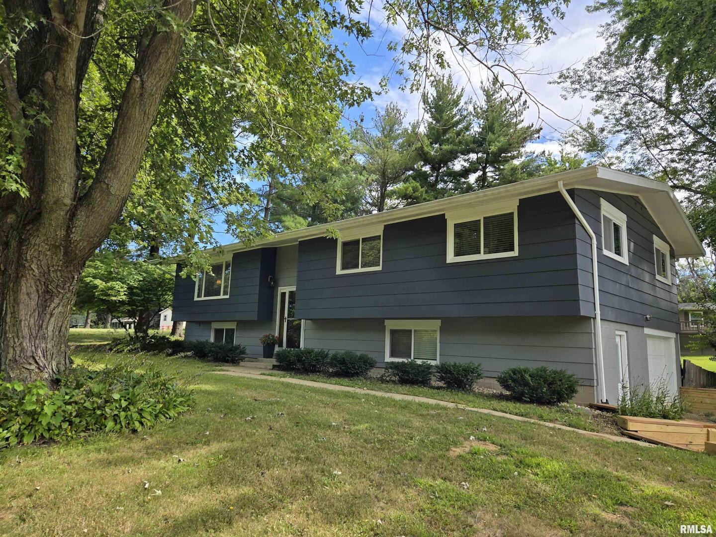 7955 Sugar Grove Road Rushville, IL 62681 - Photo 1 of 28 a front view of a house with a yard and trees