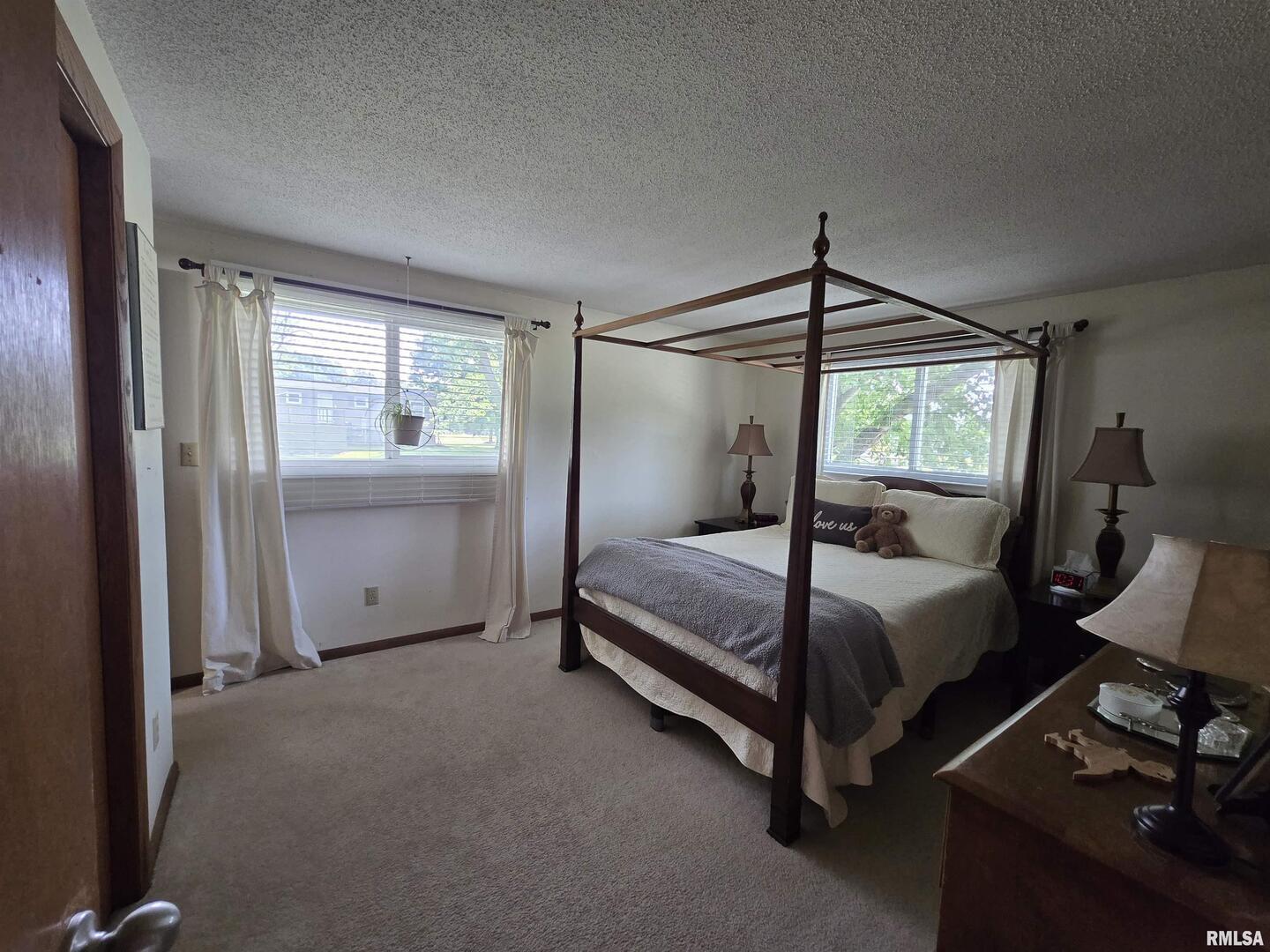 7955 Sugar Grove Road Rushville, IL 62681 - Photo 16 of 28 a bedroom with a bed and wooden floor