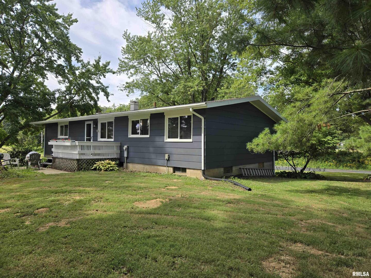 7955 Sugar Grove Road Rushville, IL 62681 - Photo 3 of 28 a backyard of a house with yard table and chairs