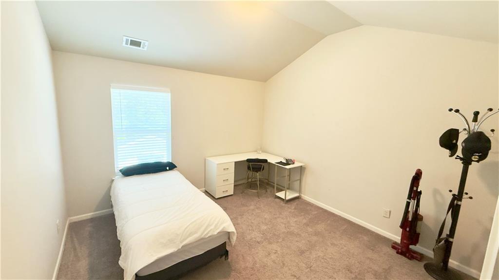 3370 Elkhorn Ridge Run Dacula, GA 30019 - Photo 23 of 29 a bedroom with a bed and cabinets