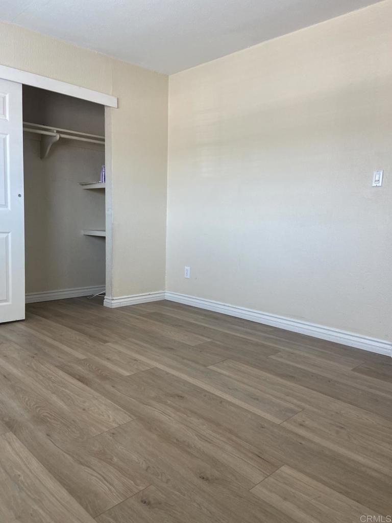917 Broadview Street Spring Valley, CA 91977 - Photo 9 of 14 a view of an empty room with wooden floor & closet