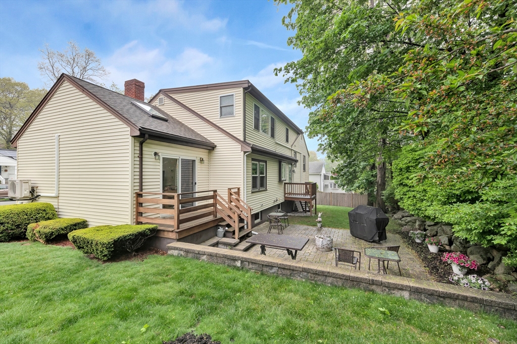 25 Kevin Road Milton, MA 02186 - Photo 11 of 39 a view of backyard of house with outdoor seating and green space