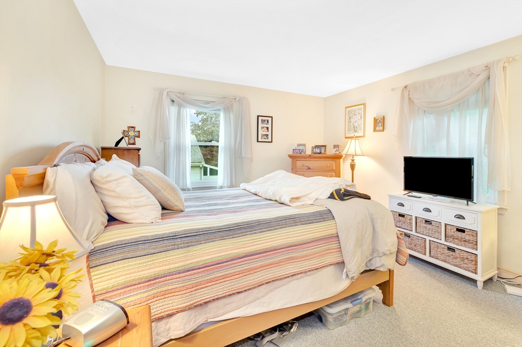 25 Kevin Road Milton, MA 02186 - Photo 16 of 39 a bedroom with a bed and a flat screen tv