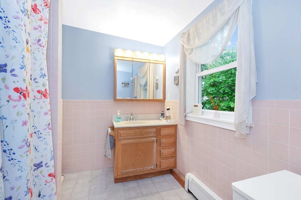 25 Kevin Road Milton, MA 02186 - Photo 19 of 39 a bathroom with a sink a toilet and a window