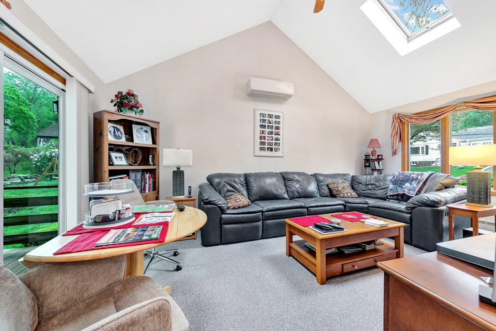 25 Kevin Road Milton, MA 02186 - Photo 28 of 39 a living room with furniture a flat screen tv and a book shelf