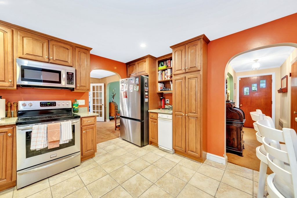 25 Kevin Road Milton, MA 02186 - Photo 34 of 39 a kitchen with stainless steel appliances granite countertop a refrigerator and a stove