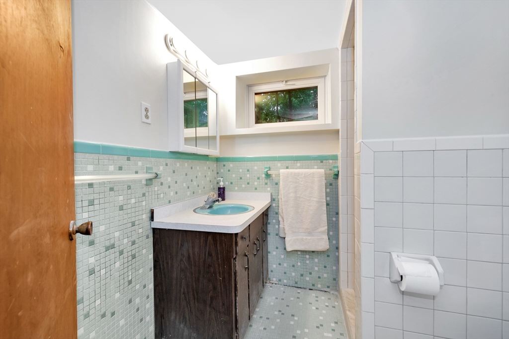 25 Kevin Road Milton, MA 02186 - Photo 37 of 39 a bathroom with a sink a toilet and mirror