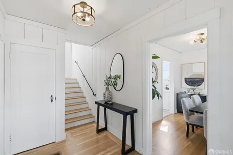 a view of entryway with workspace and wooden floor