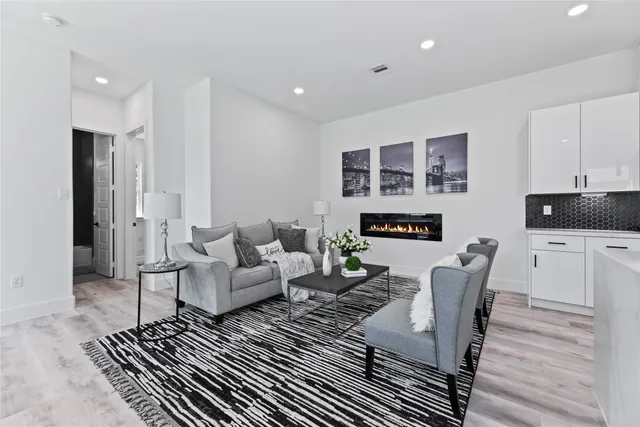 a kitchen with stainless steel appliances kitchen island granite countertop a sink and a refrigerator