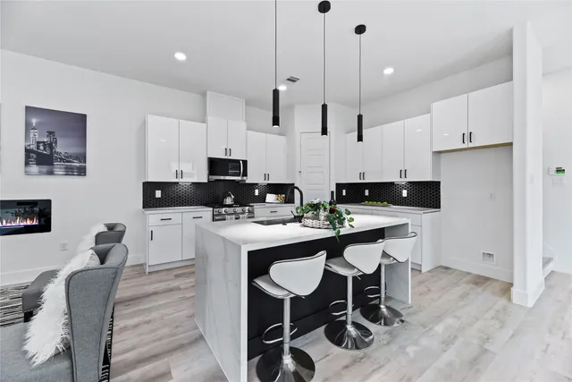 a kitchen with a sink stove and refrigerator