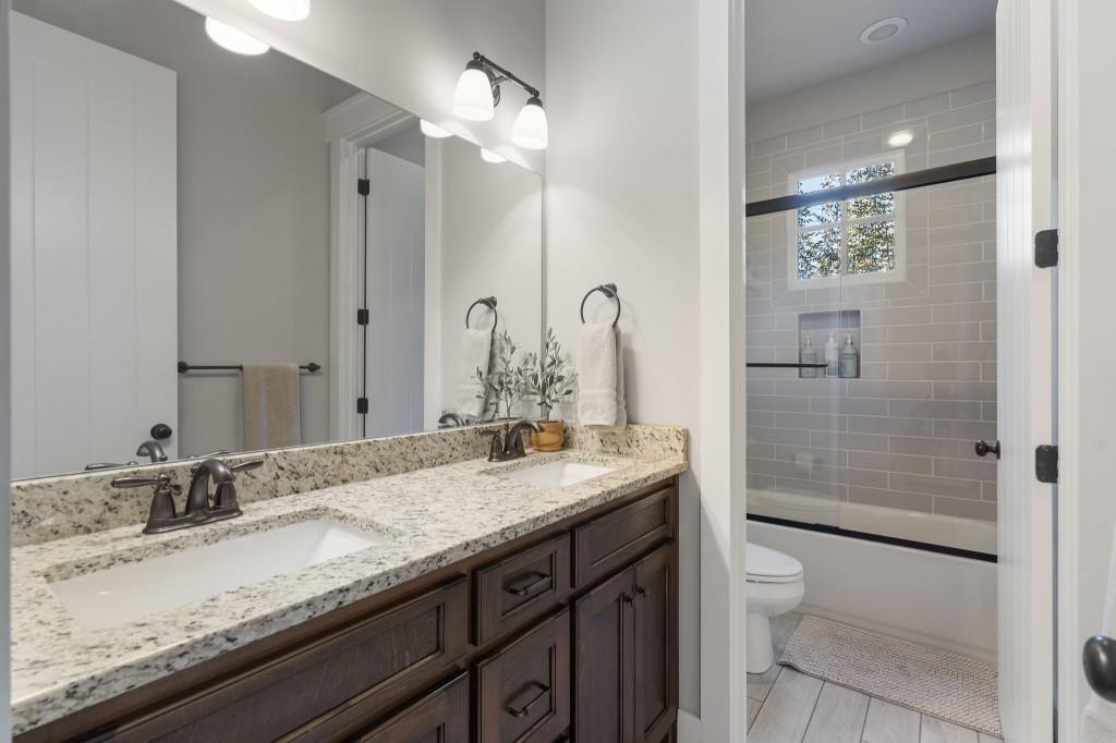 72 Buckeye Ridge Newnan, GA 30263 - Photo 38 of 80 a bathroom with a granite countertop sink a toilet and shower