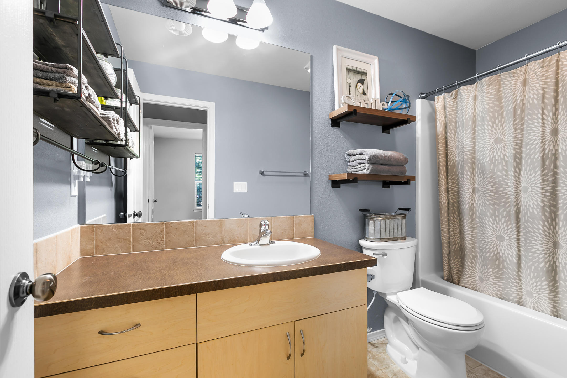 21363 Pecoraro Loop Bend, OR 97701 - Photo 14 of 15 a bathroom with a sink a toilet and shower curtain