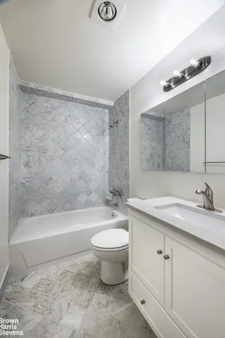 a living room with furniture a lamp and a potted plant