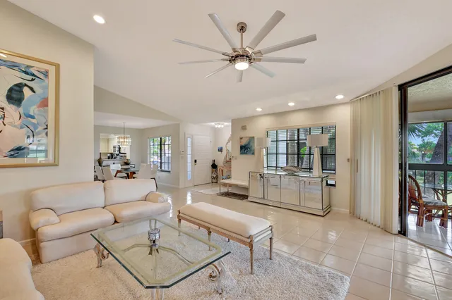 a living room with furniture and a floor to ceiling window