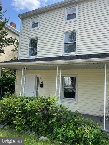 a view of a house with potted plants and a window