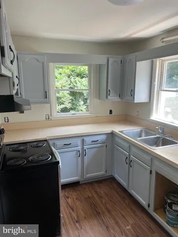 a kitchen with a sink stove and cabinets