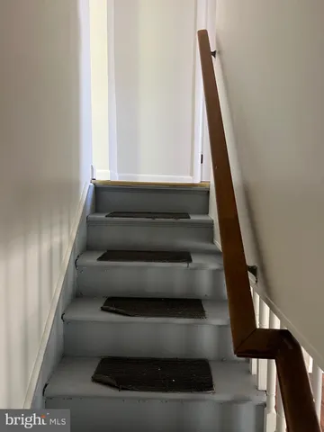 a view of staircase with white walls and a window