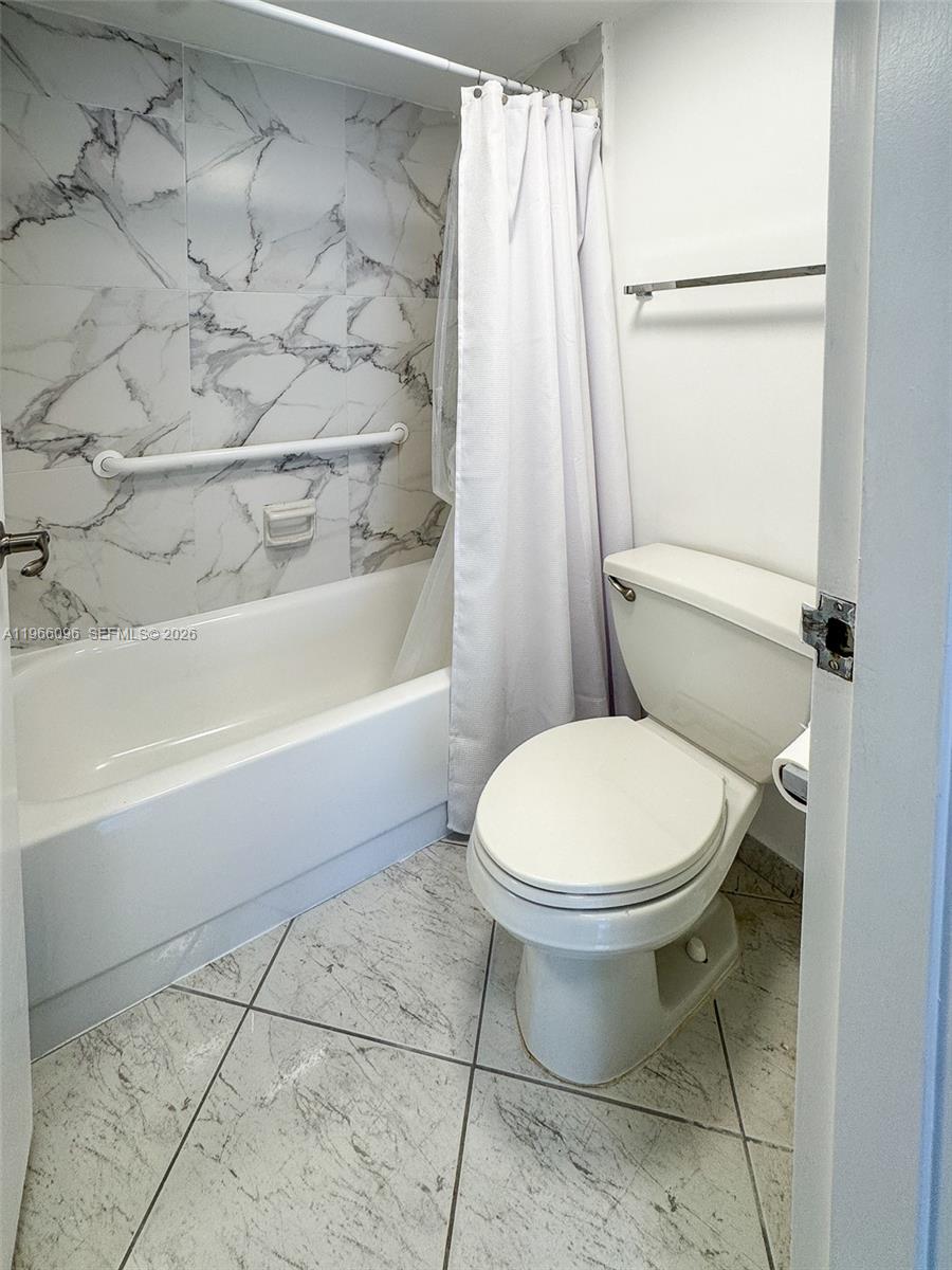 9225 Collins Avenue, Unit 609 Surfside, FL 33154 - Photo 13 of 27 a bathroom with a toilet and a shower