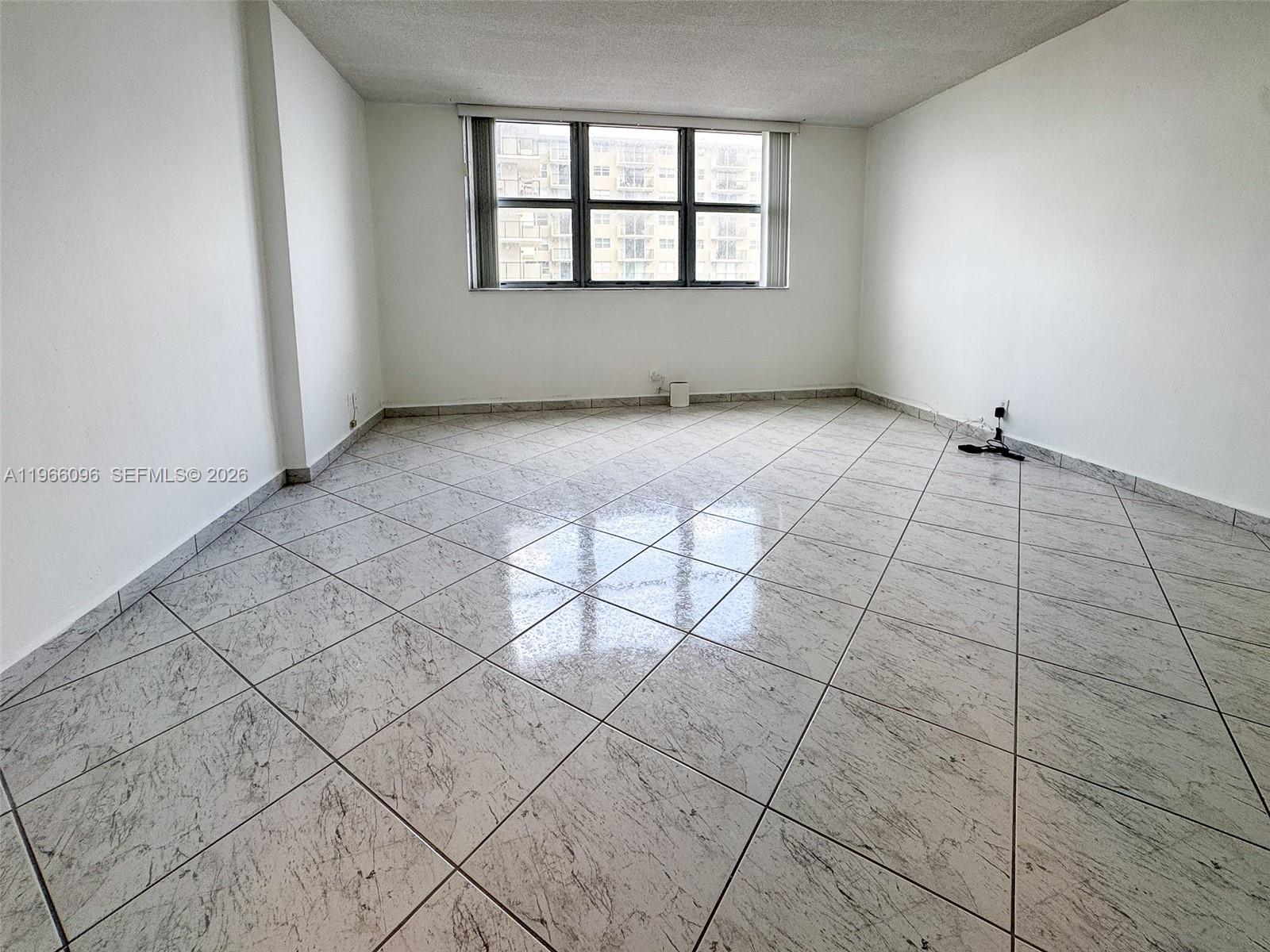 9225 Collins Avenue, Unit 609 Surfside, FL 33154 - Photo 14 of 27 a view of an empty room with a window