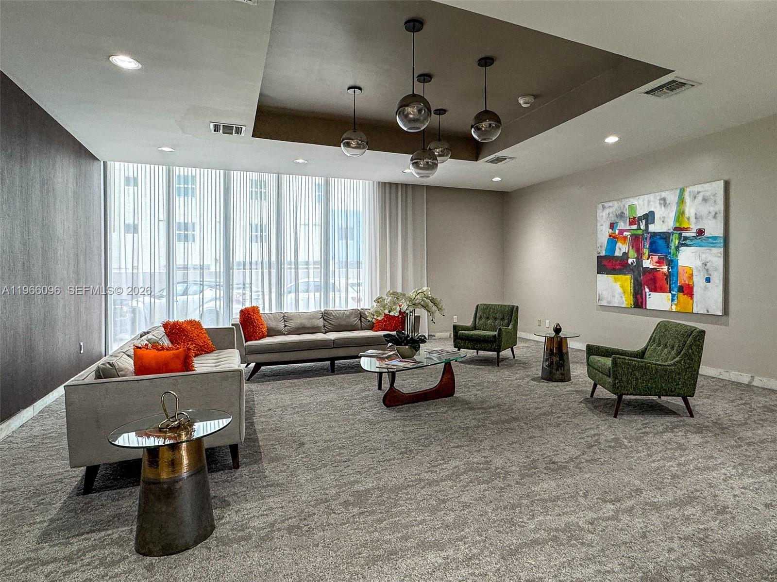 9225 Collins Avenue, Unit 609 Surfside, FL 33154 - Photo 22 of 27 a living room with furniture and a projector screen