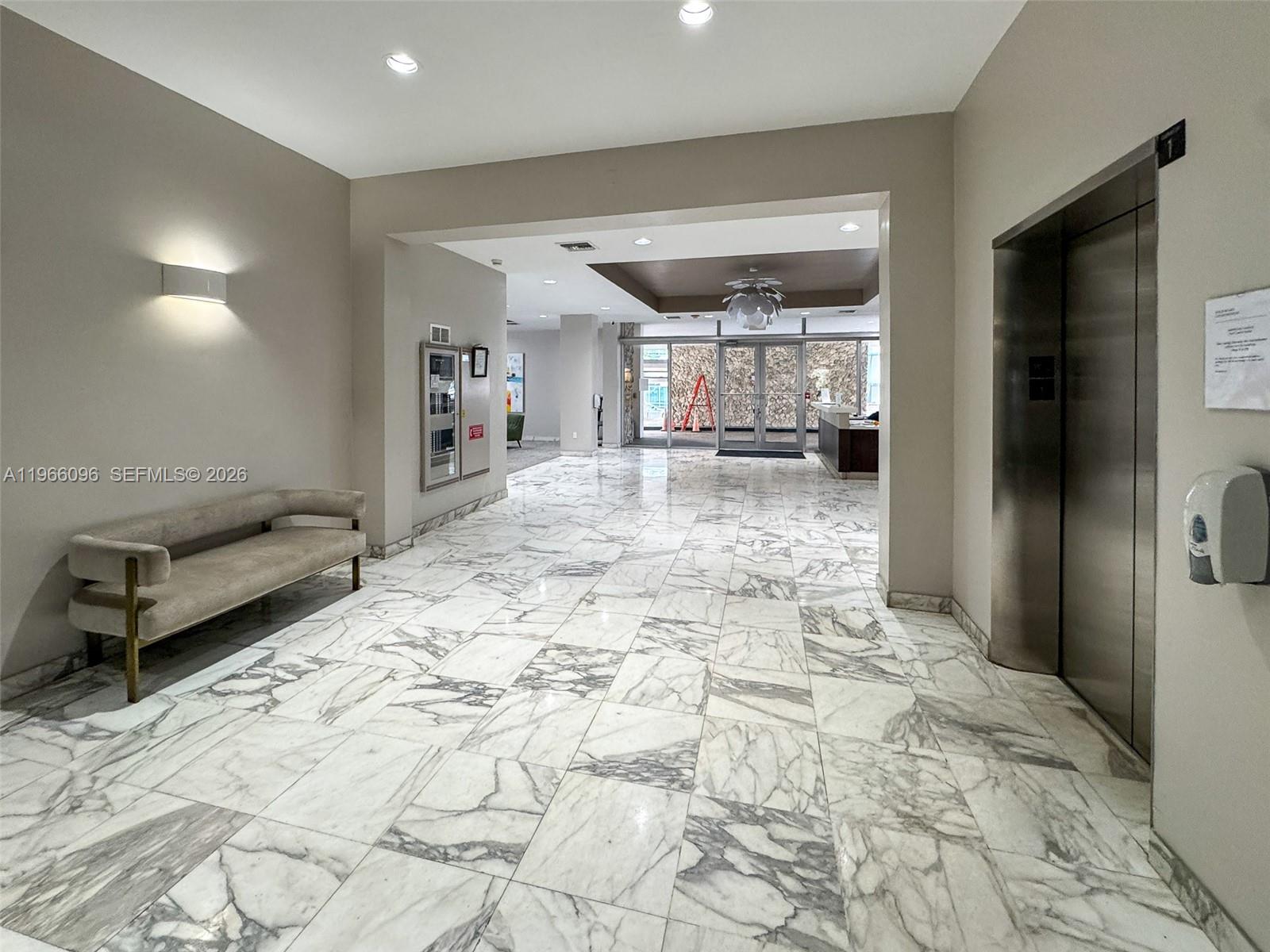 9225 Collins Avenue, Unit 609 Surfside, FL 33154 - Photo 24 of 27 a bathroom with a sink and a mirror