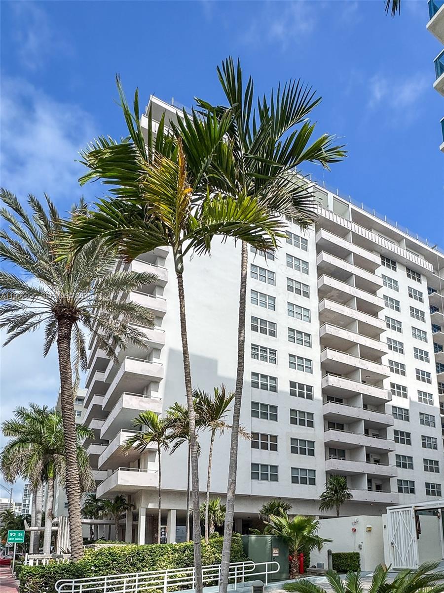 9225 Collins Avenue, Unit 609 Surfside, FL 33154 - Photo 26 of 27 a view of a palm tree in front of a building