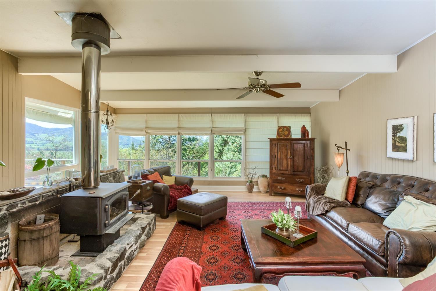 2820 Quail Run Road Talent, OR 97540 - Photo 9 of 30 a living room with furniture ceiling fan and a window