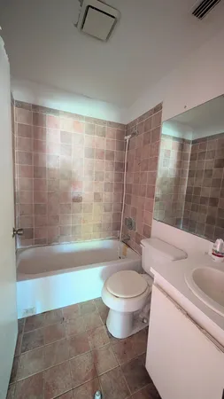 a bath room with a toilet and a bath tub